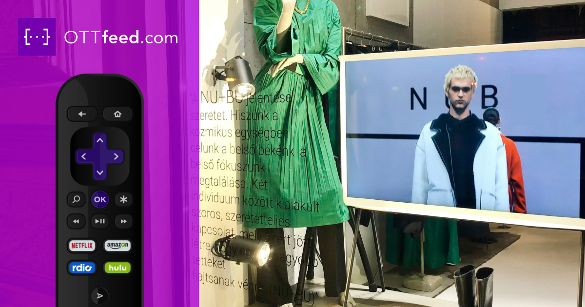 Retail store display window featuring a TV screen showing a fashion runway video.